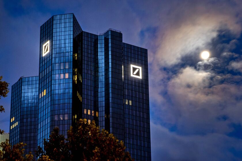 FILE — In this Oct. 4, 2020, file photo, the moon shines next to the headquarters of the Deutsche Bank in Frankfurt, Germany. Deutsche Bank has agreed to pay a fine of more than $100 million to avoid a criminal prosecution on charges it participated in a foreign bribery scheme. Lawyers for the bank waived its right to face an indictment on conspiracy charges Friday, Jan. 8, 2021, during a teleconference with a federal judge in New York City. (AP Photo/Michael Probst, File)