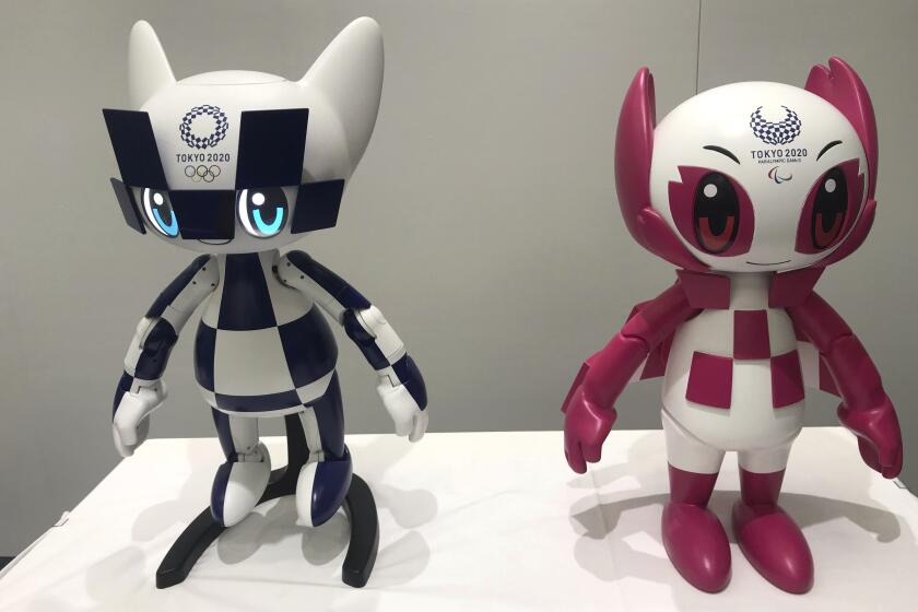 Robots of Tokyo 2020 mascots Miraitowa, left, and Someity are shown to the media July 18 at Toyota Motor Corp. headquarters in Tokyo.