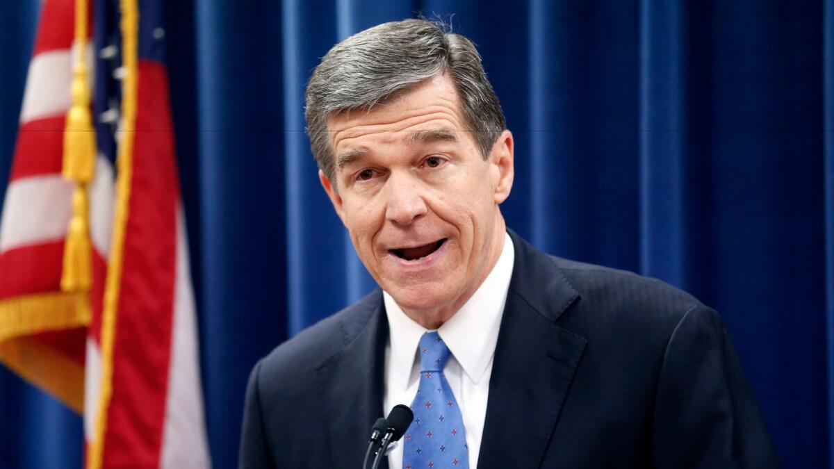 Roy Cooper, then governor-elect of North Carolina, speaks in December at a news conference criticizing Republican efforts to cut the power of his office.