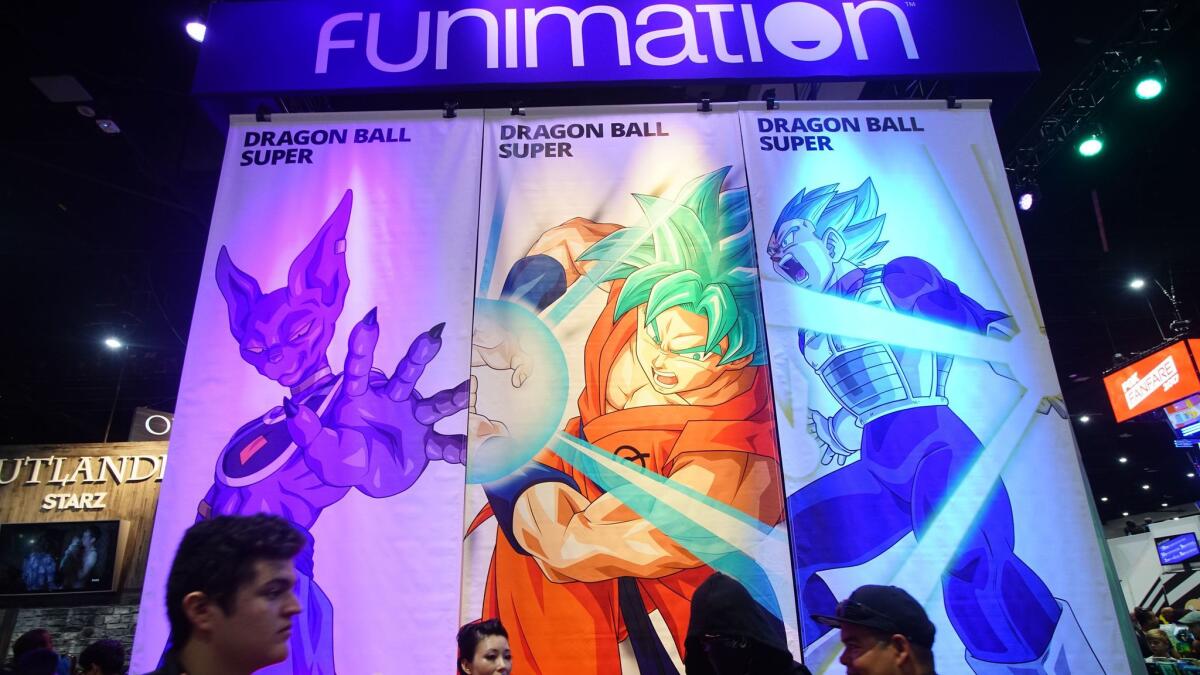 Attendees walk in front of the Funimation booth at this year's Comic-Con International in San Diego.