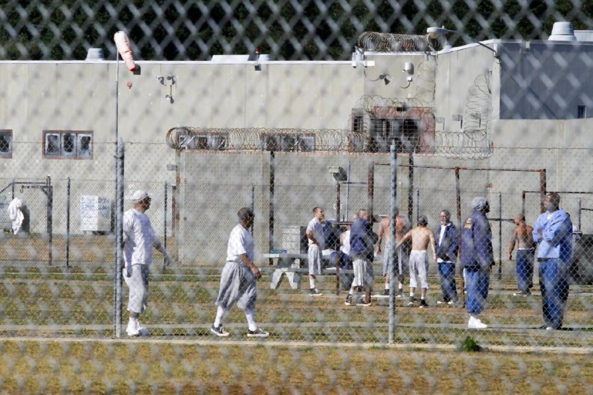 Inmates in Unit B at Pelican Bay State Prison in Crescent City, Calif., exercise and a talk in the yard in October.