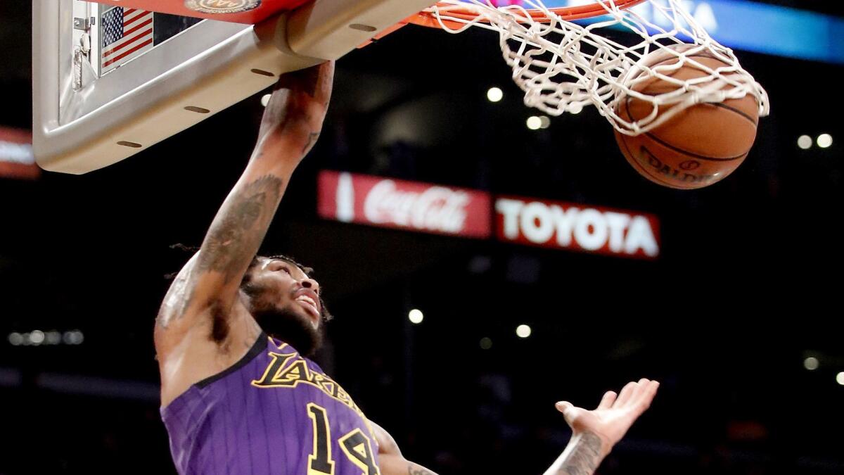 Lakers swingman Brandon Ingram throws down a dunk against the Mavericks during a game last month.