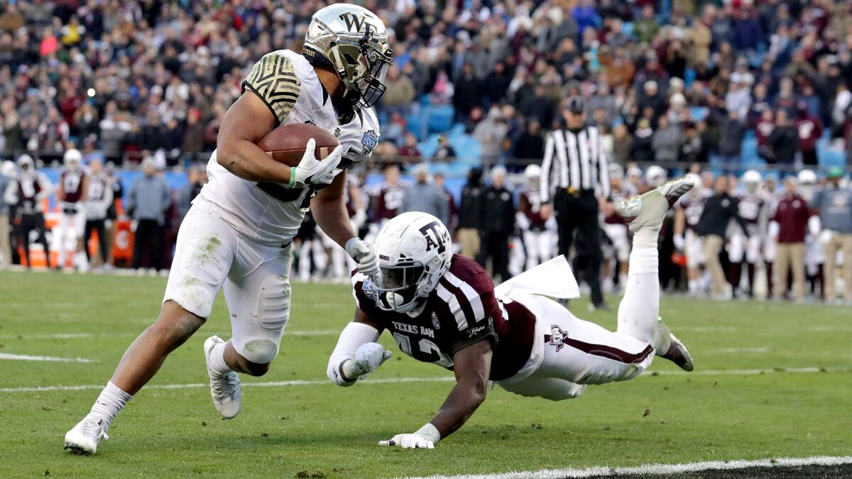 Wake Forest running back Matt Colburn evades Texas A&M linebacker Otaro Alaka to score what proved to be the game-winning touchdown Friday in the Belk Bowl.