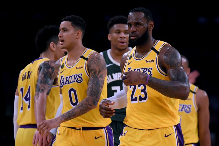 LOS ANGELES, CALIFORNIA - MARCH 06: LeBron James #23 and Kyle Kuzma #0 of the Los Angeles Lakers react after a James score, in front of Giannis Antetokounmpo #34 of the Milwaukee Bucks during a 113-103 Laker win at Staples Center on March 06, 2020 in Los Angeles, California. NOTE TO USER: User expressly acknowledges and agrees that, by downloading and or using this photograph, User is consenting to the terms and conditions of the Getty Images License Agreement. (Photo by Harry How/Getty Images)