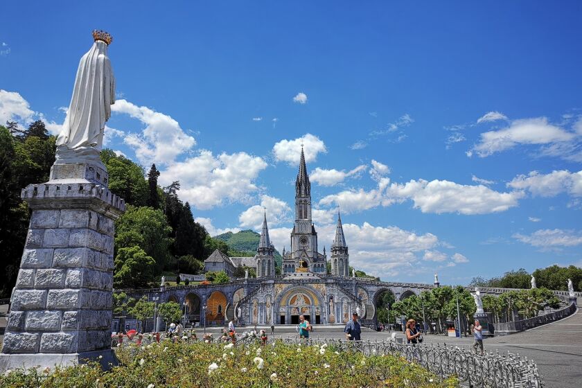 LOURDES, France Ð JUNE 18, 2019: The Sanctuary of Our Lady of Lourdes (Notre Dame de Lourdes) is the centerpiece of the city and features a soaring Gothic cathedral built over the grotto where Bernadette had her visions.