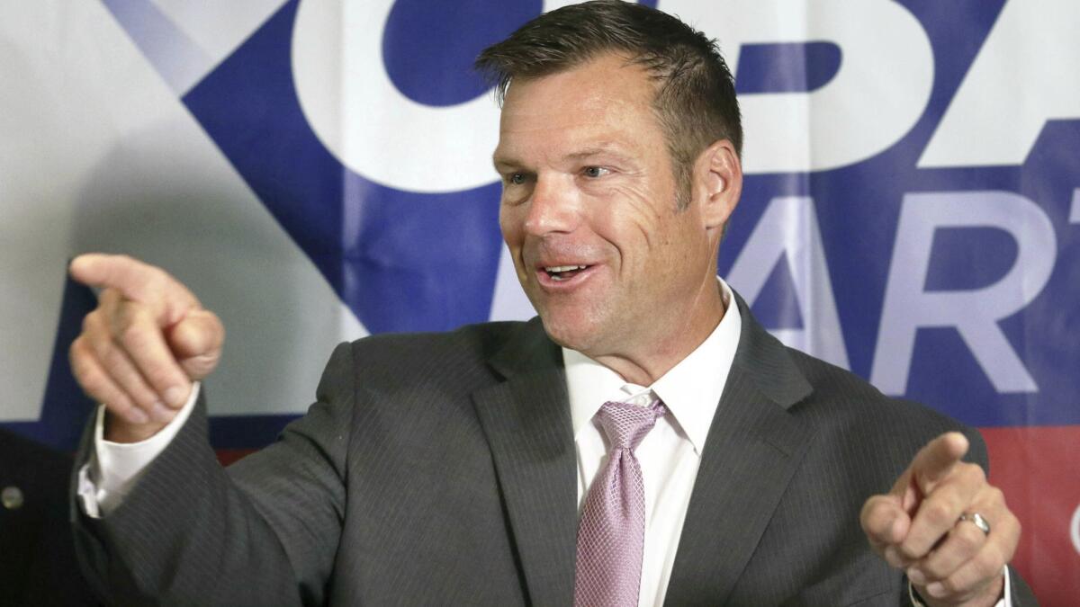 Kansas Secretary of State Kris Kobach speaks to reporters Wednesday in Topeka. On Thursday, his lead shrunk from 191 votes to 121 out of 311,000 ballots cast.