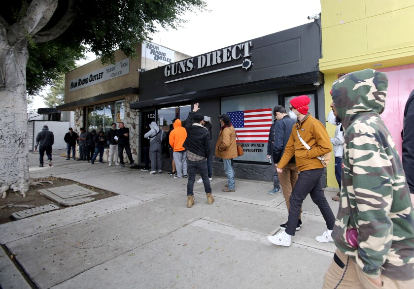 Customers line up outside Guns Direct on Magnolia Avenue in Burbank on March 17.