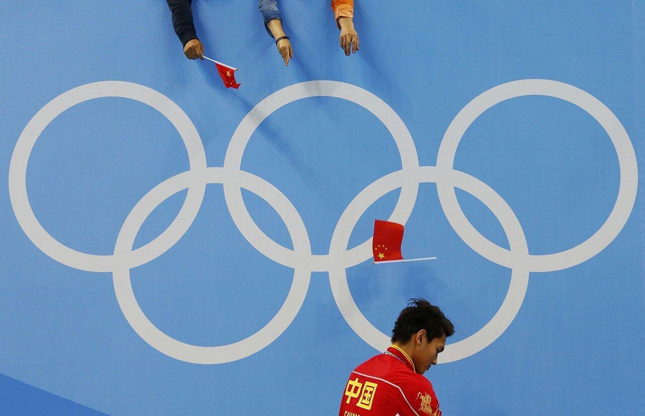 Fans throw a flag at Xu Jiayu of China after he won silver during the 2016 Olympics men's 100m backstroke victory ceremony at Olympic Aquatics Stadium in Rio de Janeiro, Brazil.