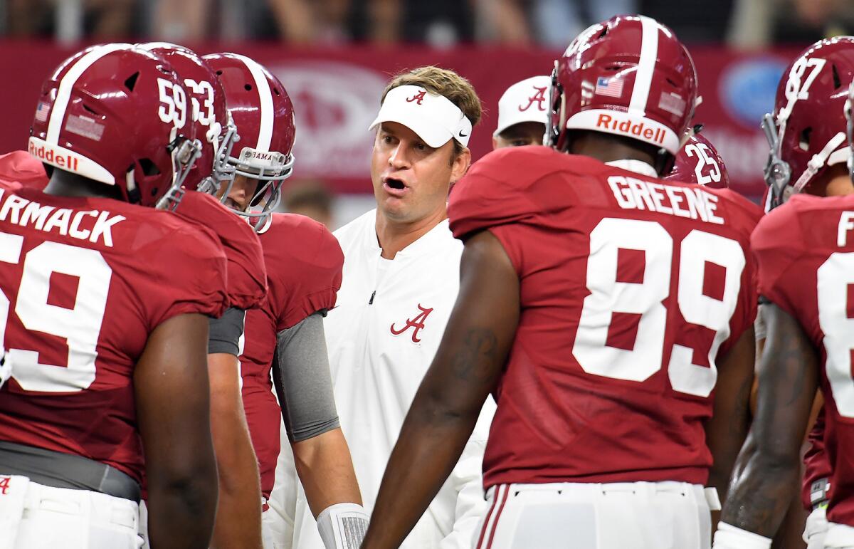 Alabama offensive coordinator Lane Kiffin talks to his players during the season opener against USC.