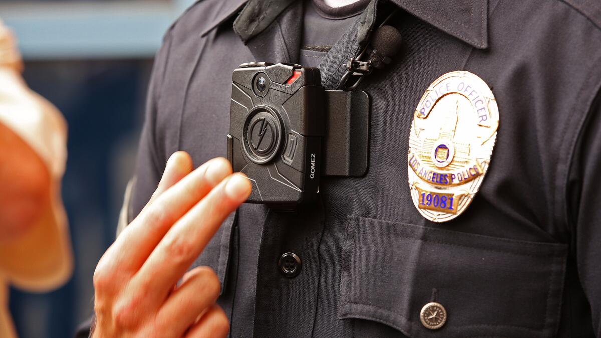 Los Angeles Police Officer Jim Stover demonstrates a new LAPD body camera on Sept. 4, 2015.