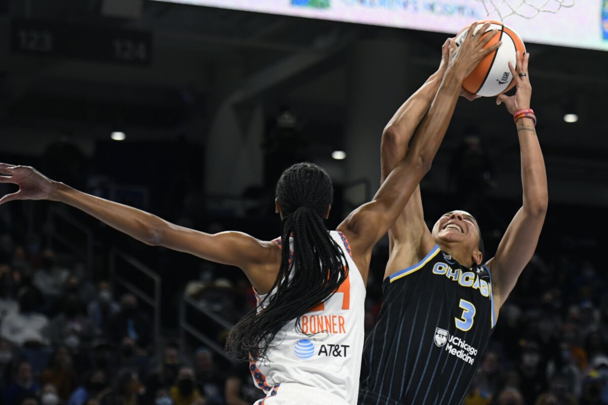 Chicago Sky's Candice Parker (3) shoots while being fouled by Connecticut Sun's DeWanna Bonner (24) during the first half of Game 4 of a WNBA basketball playoff semifinal, Wednesday, Oct. 6, 2021, in Chicago. (AP Photo/Paul Beaty)
