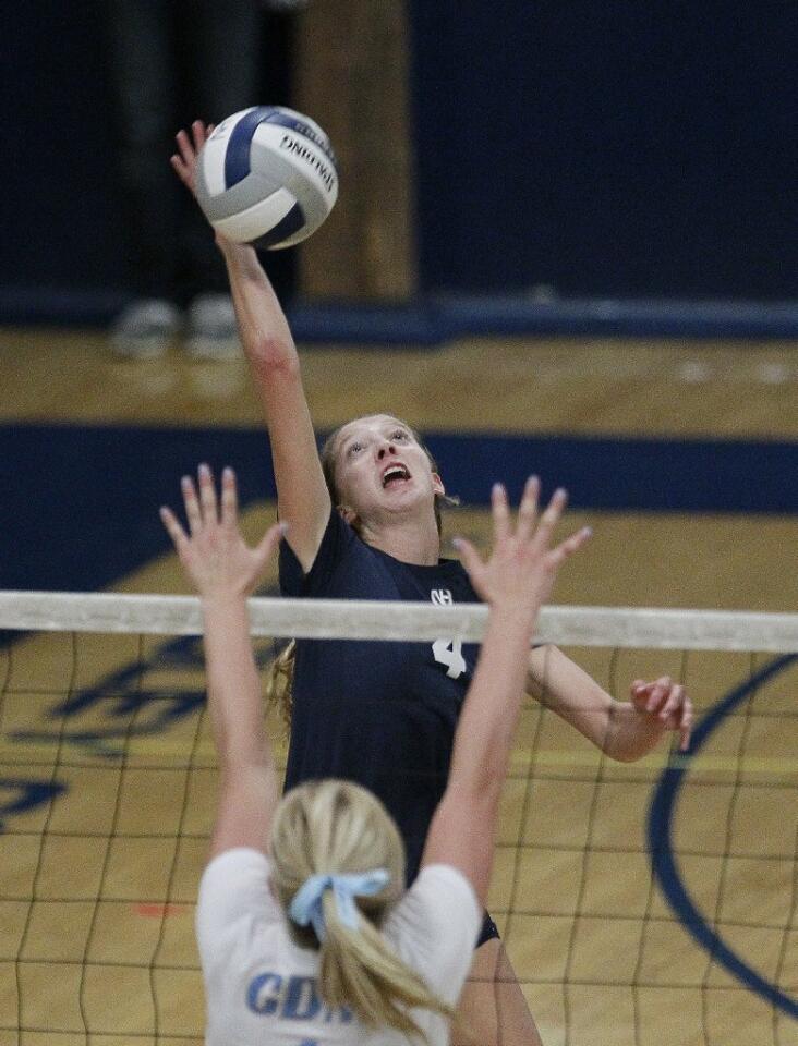 Newport Harbor High's Leah Castillo hits over Corona del Mar's Katie Craig during the Battle of the Bay girls' volleyball match on Saturday.