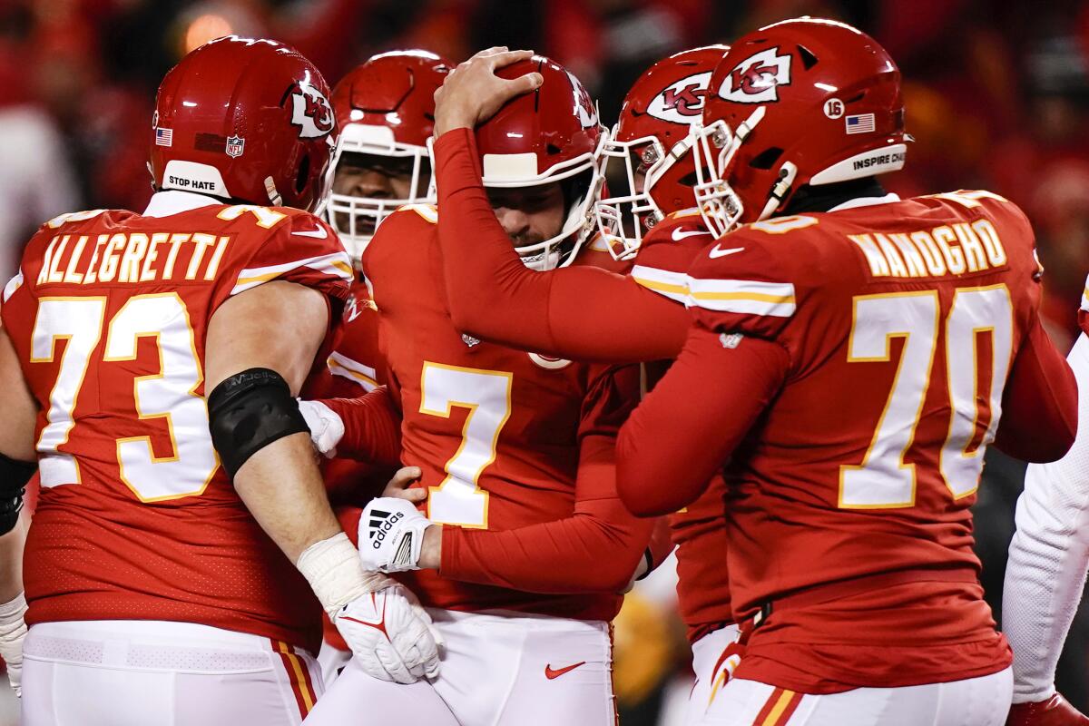 Harrison Butker celebrates with teammates after kicking a field goal in the final seconds.
