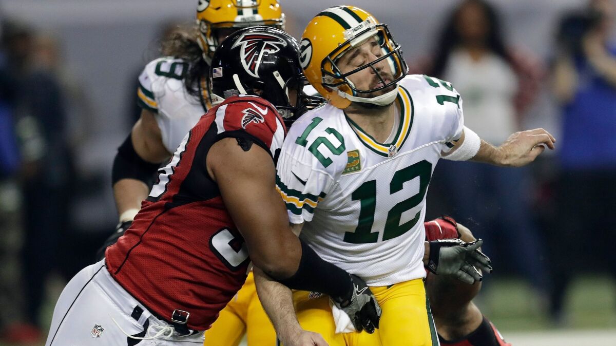 Atlanta Falcons defensive end Dwight Freeney hits Green Bay Packers' quarterback Aaron Rodgers during the NFC championship game on Jan. 22.