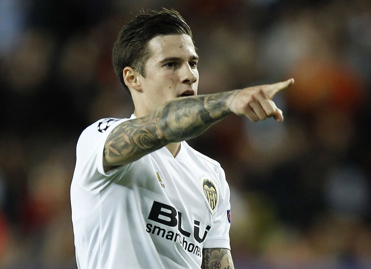 FILE - Valencia's Santi Mina celebrates after scoring during a Group H Champions League soccer match against Young Boys at the Mestalla Stadium in Valencia, Spain, Nov. 7, 2018. Celta Vigo forward Santi Mina and another Spanish soccer player accused of raping a woman have maintained their innocence on the closing day of their trial, Friday, April 1, 2022. A state prosecutor is asking for eight years of prison for Mina. The alleged victim’s own lawyers are seeking nine-and-a-half years for having allegedly forced her to have sexual relations in 2017. (AP Photo/Alberto Saiz)