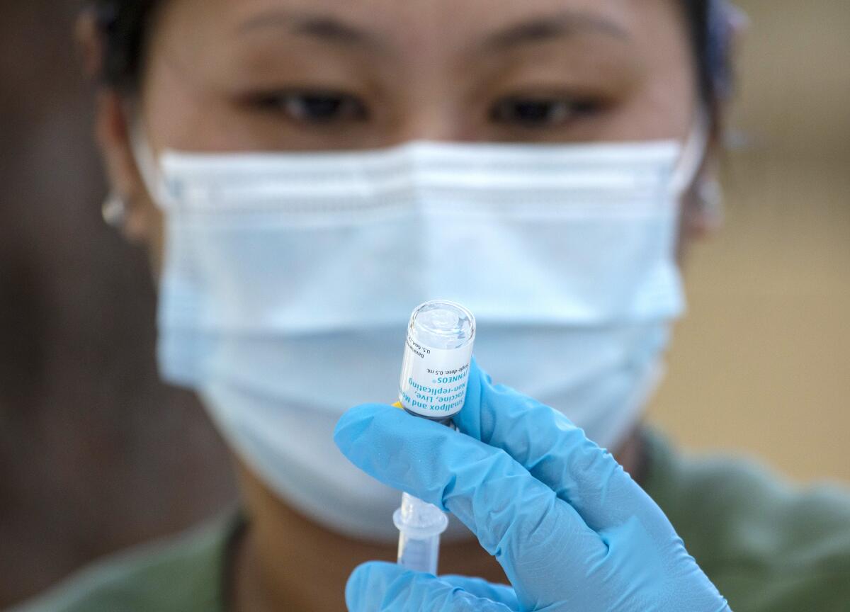 Pharmacist Ngoc-Chau Tran fills syringes with monkeypox vaccine at a  walk-up vaccination site at Barnsdall Art Park 