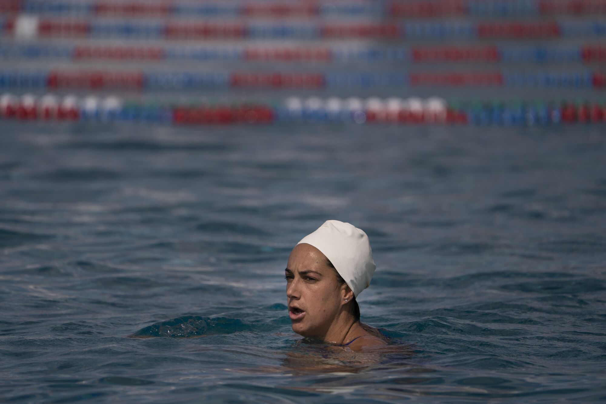 A woman polo player treads water.