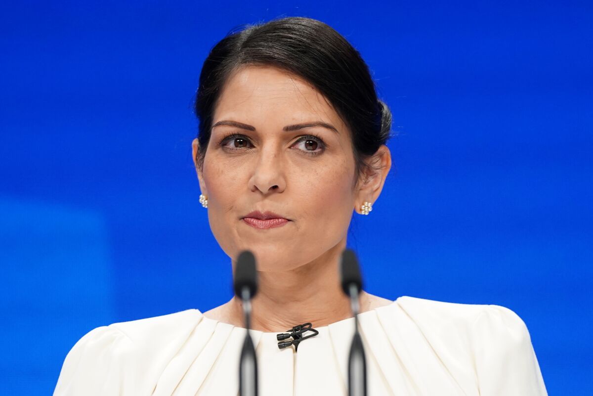 Britain's Home Secretary Priti Patel pauses as she speaks at the Conservative Party Conference in Manchester, England, Tuesday, Oct. 5, 2021. (Stefan Rousseau/PA via AP)
