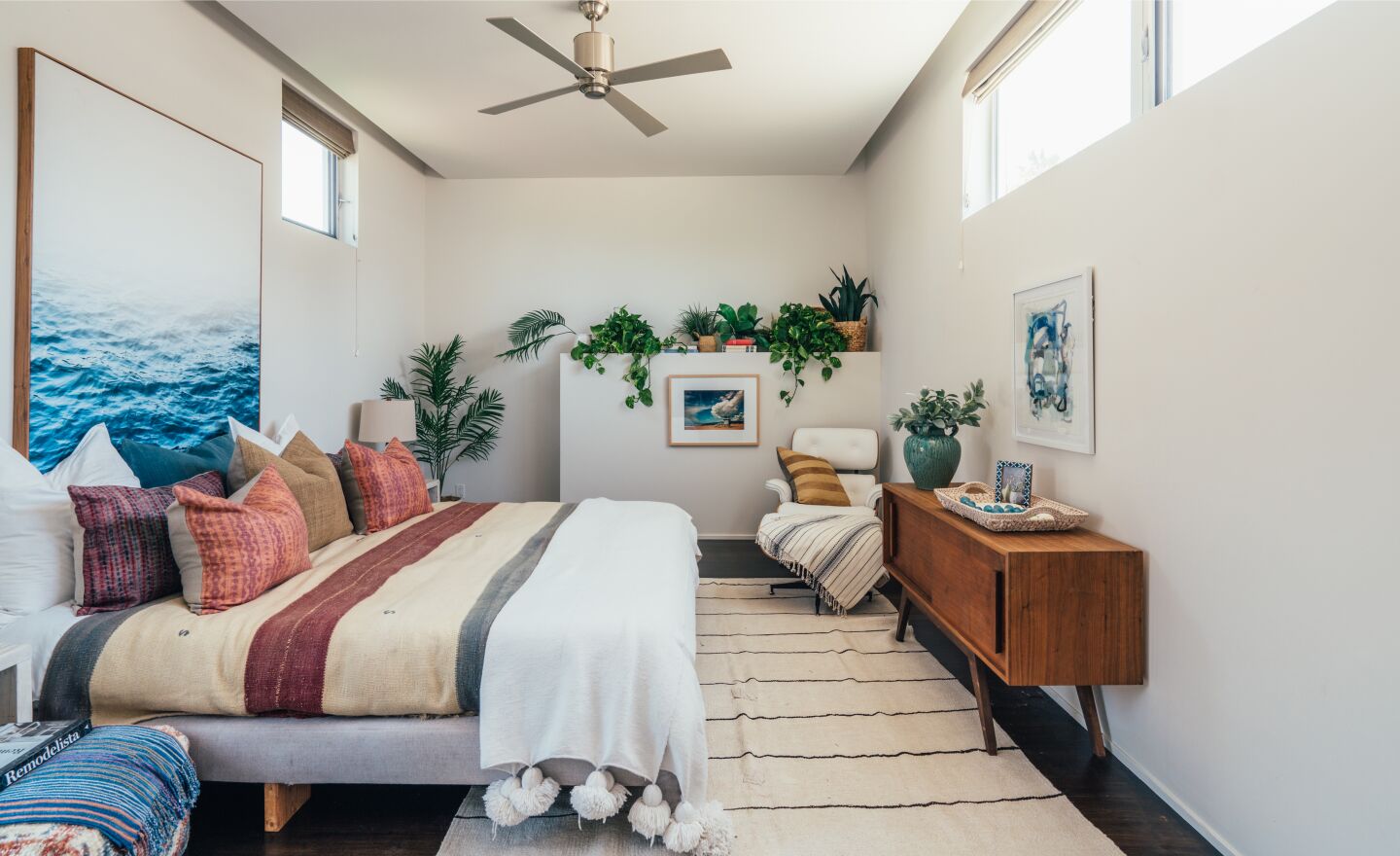 The guest bedroom is furnished and has windows.