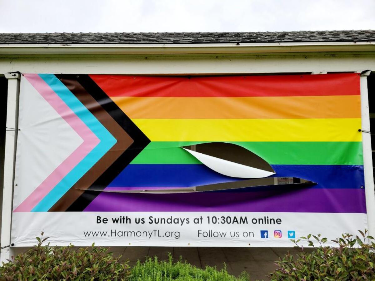 An LGBTQ+ pride banner.