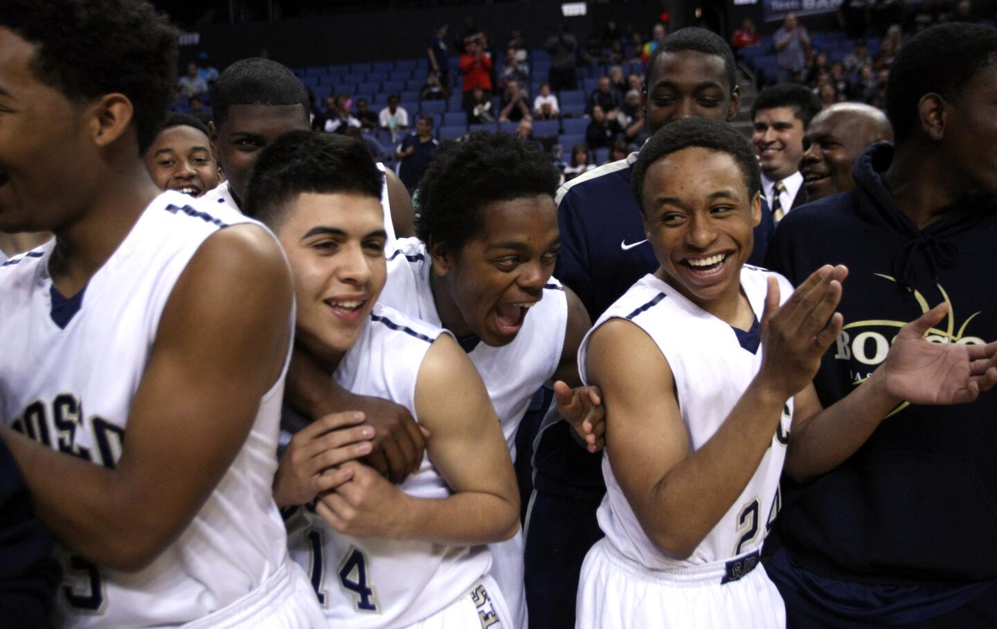 St. John Bosco's Ray Knight Jr., left, Giovanni Fernandez, Abdul Zaid and Isaiah LeBlanc celebrate the Braves' 72-55 win over Compton in the Southern California Regional Division II final Saturday at Citizens Business Bank Arena.