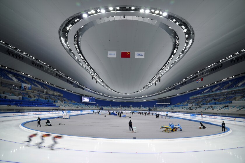 Skaters compete during the Speed Skating China Open, a test event for the 2022 Winter Olympics, at the National Speed Skating Oval in Beijing, Saturday, Oct. 9, 2021. The venue will host speed skating competition at the upcoming 2022 Beijing Winter Olympics. (AP Photo/Mark Schiefelbein)