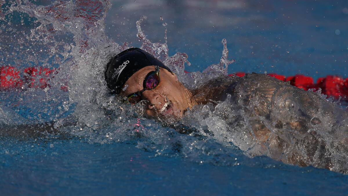Caeleb Dressel competes in the men's 200-meter freestyle preliminary race 