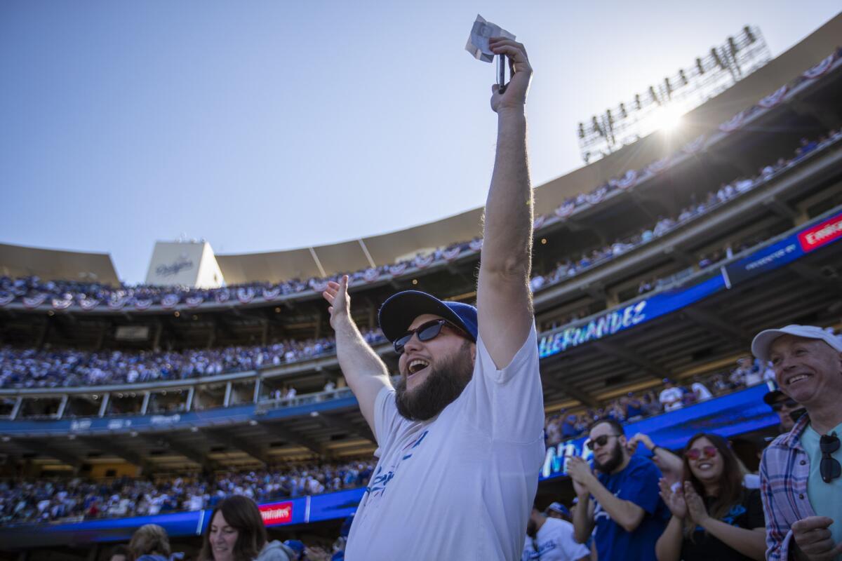 Dodgers fan Elliott Kirschenmann of Bakersfield celebrates Enrique Hernandez’s seventh-inning home run on opening day. Hernandez hit two homers in the game.