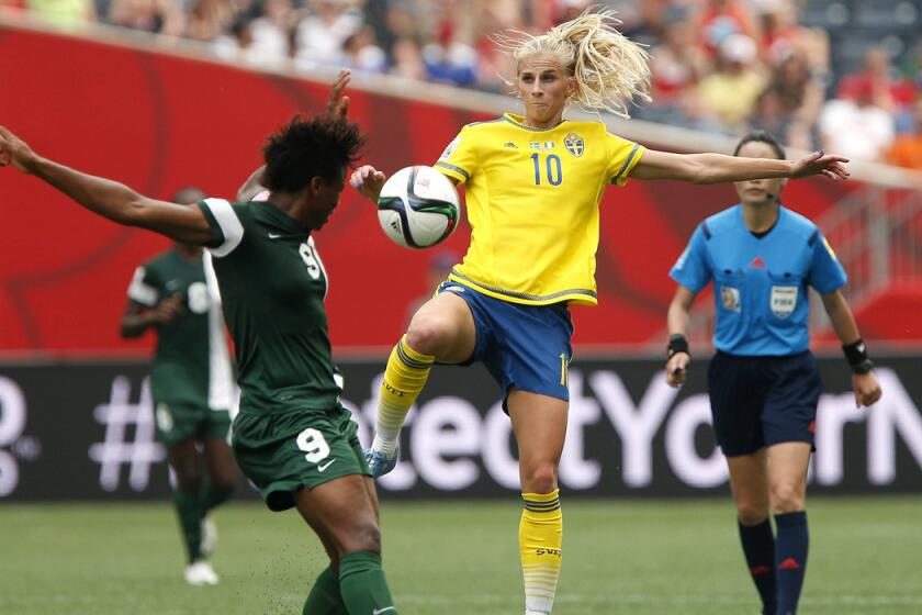 Sweden's Sofia Jakobsson (10) goes up for the ball against Nigeria's Desire Oparanozie (9) during the second half of a FIFA Women's World Cup soccer match on Monday.