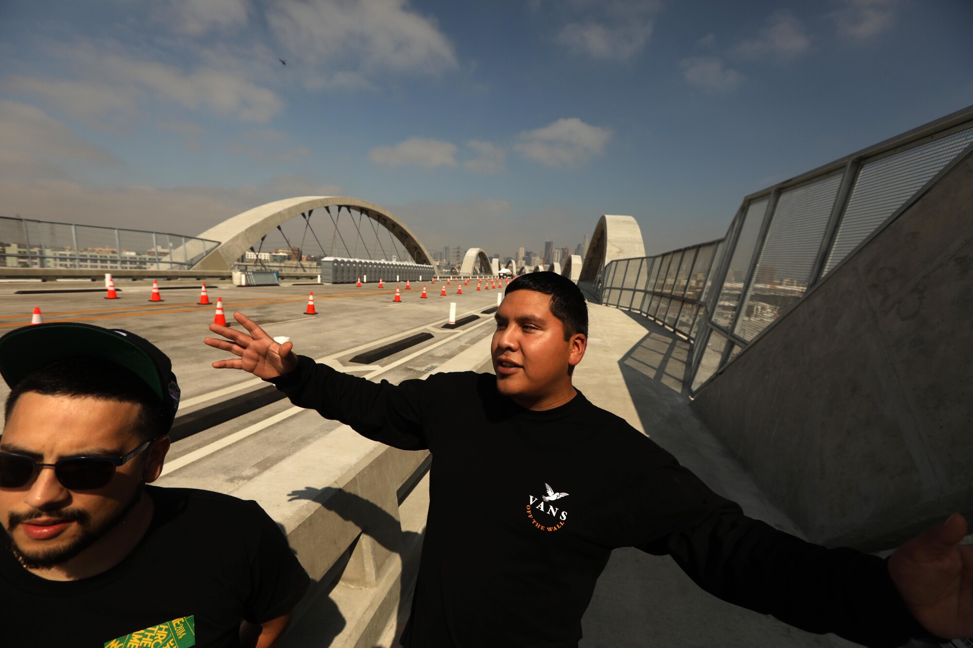 Two men walk across the new 6th Street Viaduct.