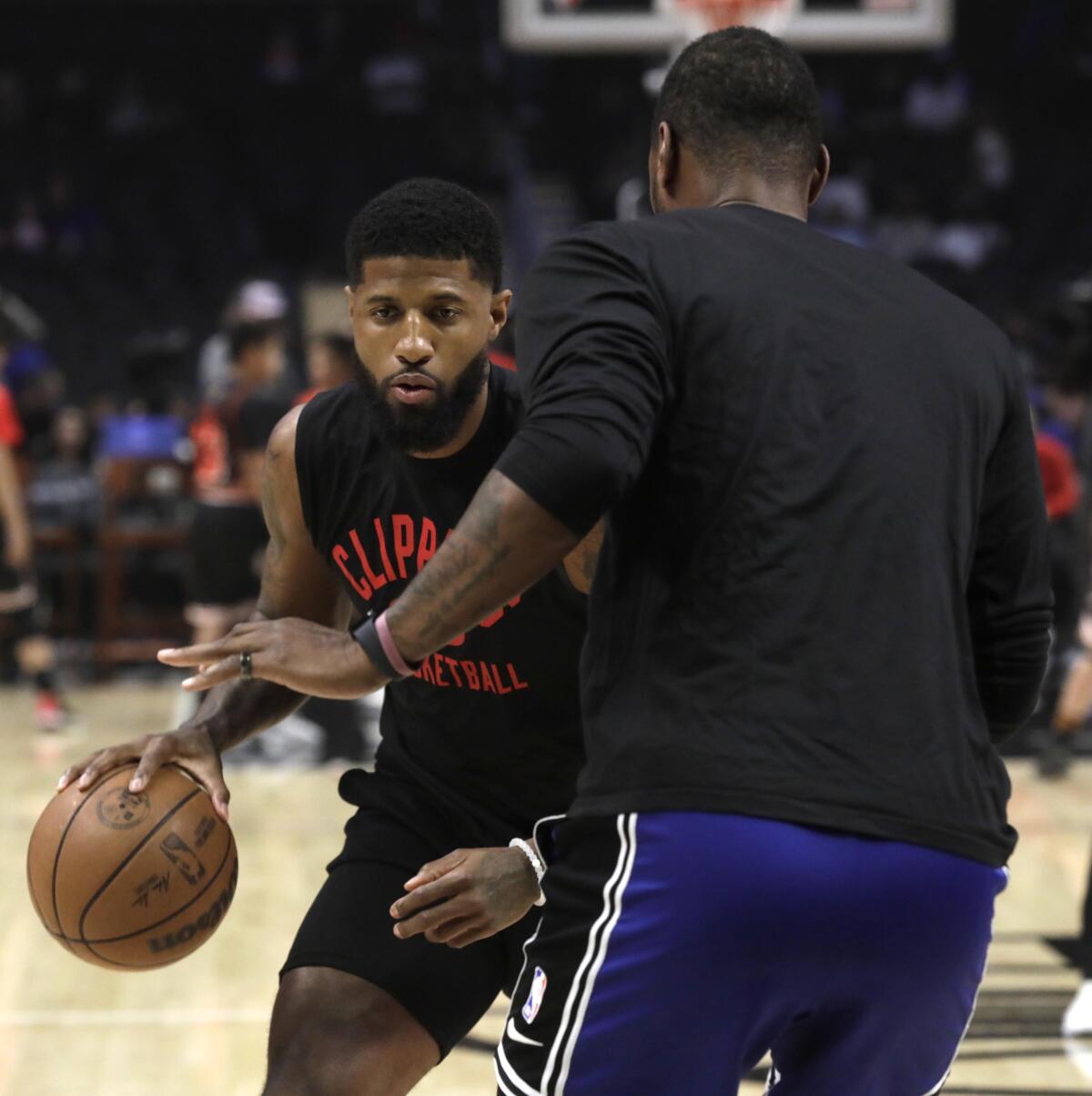 Clippers guard Paul George practices before Friday's game against the 76ers.