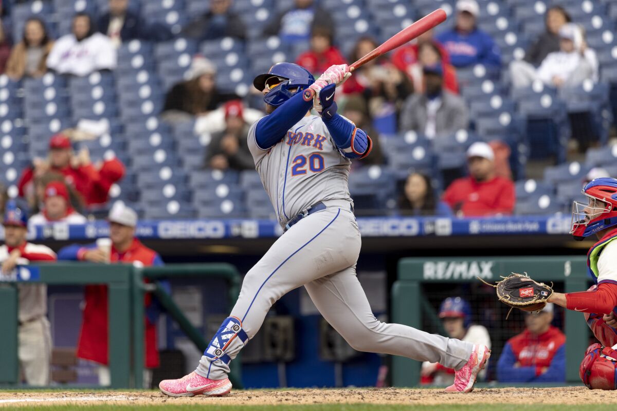 New York Mets designated hitter Pete Alonso (20) follows through on a three-run home run during the fifth inning of the second game of a baseball doubleheader against the Philadelphia Phillies, Sunday, May 8, 2022, in Philadelphia. (AP Photo/Laurence Kesterson)