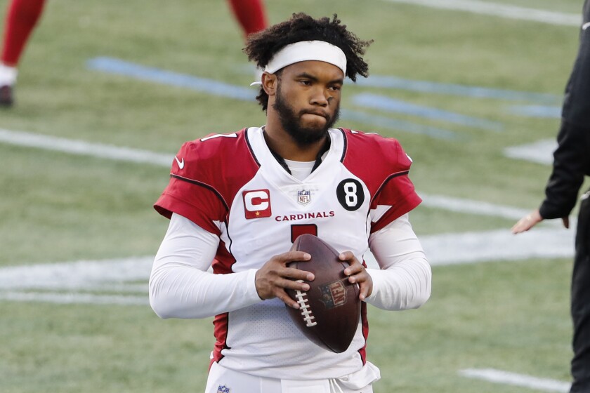 Arizona Cardinals quarterback Kyler Murray holds the ball on the sideline.