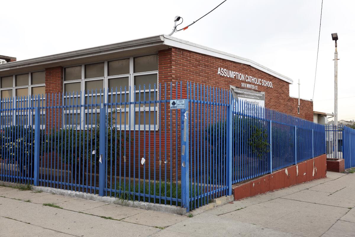Blue fencing surround Assumption Catholic School in Boyle Heights.