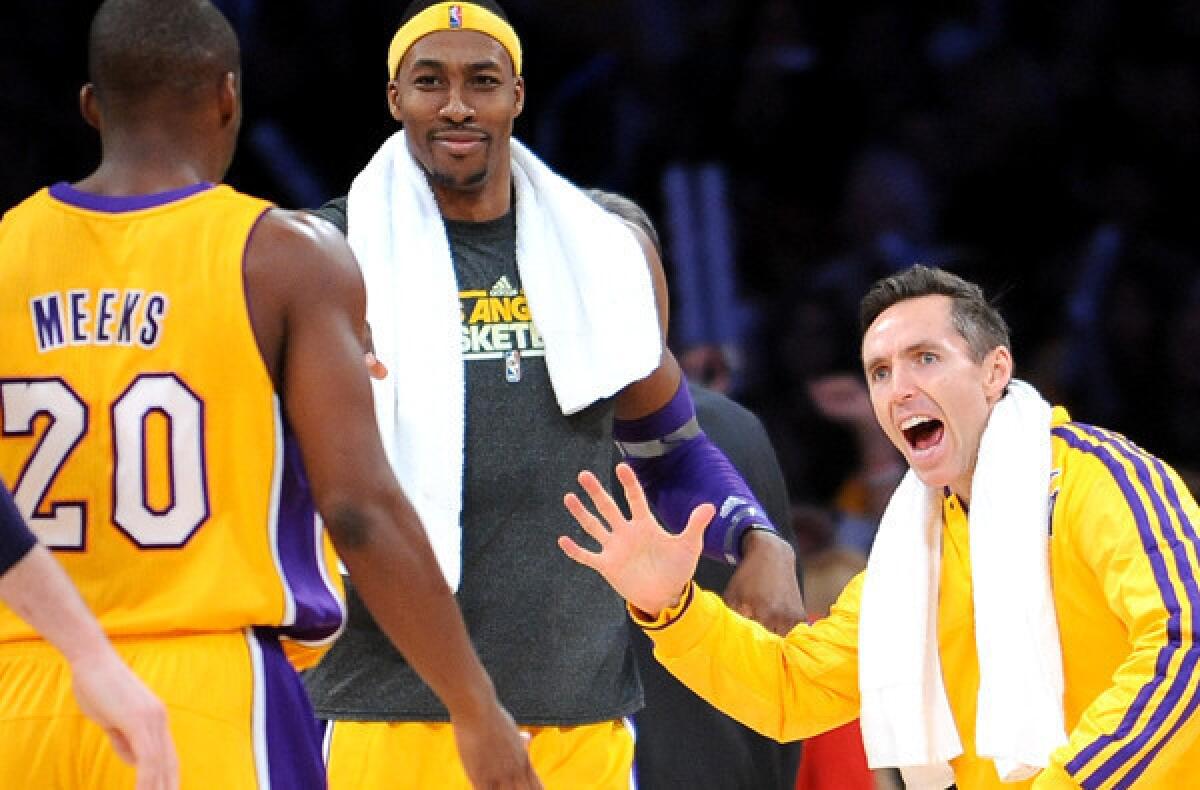 Dwight Howard, center, and Steve Nash congratulate Jodie Meeks after he made a three-pointer against the Portland Trail Blazers during a game last season at Staples Center.