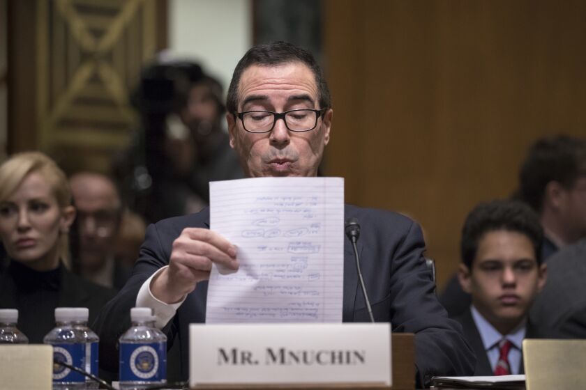 Treasury Secretary-designate Steven Mnuchin goes over notes while testifying on Capitol Hill in Washington, Thursday, Jan. 19, 2017, at his confirmation hearing before the Senate Finance Committee. Mnuchin built his reputation and his fortune as a savvy Wall Street investor but critics charge that he profited from thousands of home foreclosures as the chief of a sub-prime mortgage lender during the housing collapse. (AP Photo/J. Scott Applewhite)