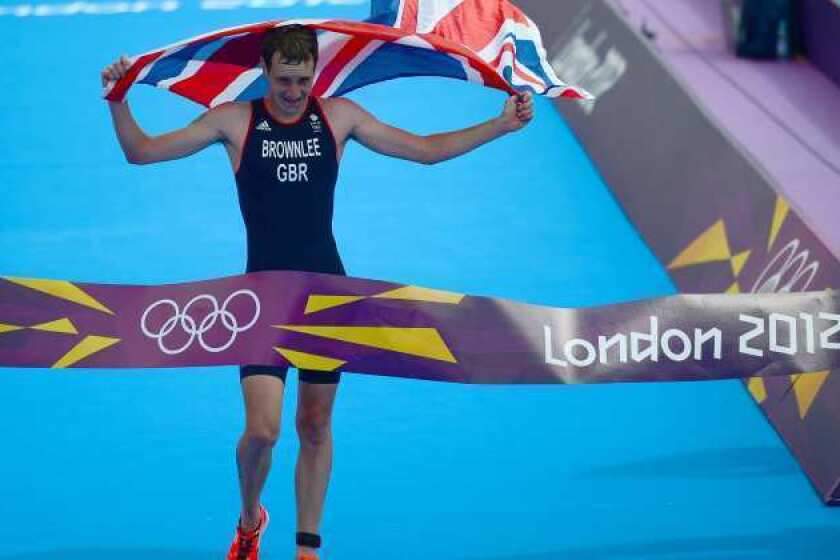 Alistair Brownlee of Britain crosses the finish line to take the gold medal in the men's triathlon.
