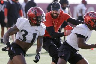 SAN DIEGO, CA - MARCH 12, 2024: Head coach Sean Lewis runs along side of his players during Aztecs spring football practice at SDSU in San Diego on Tuesday, March 12, 2024. (Hayne Palmour IV / For The San Diego Union-Tribune)