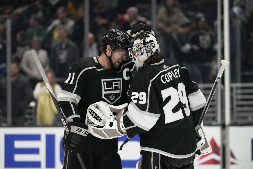 Los Angeles Kings' Anze Kopitar (11) and goaltender Pheonix Copley (29) celebrate the team's 4-2 win against the Washington Capitals in an NHL hockey game Monday, March 6, 2023, in Los Angeles. (AP Photo/Jae C. Hong)