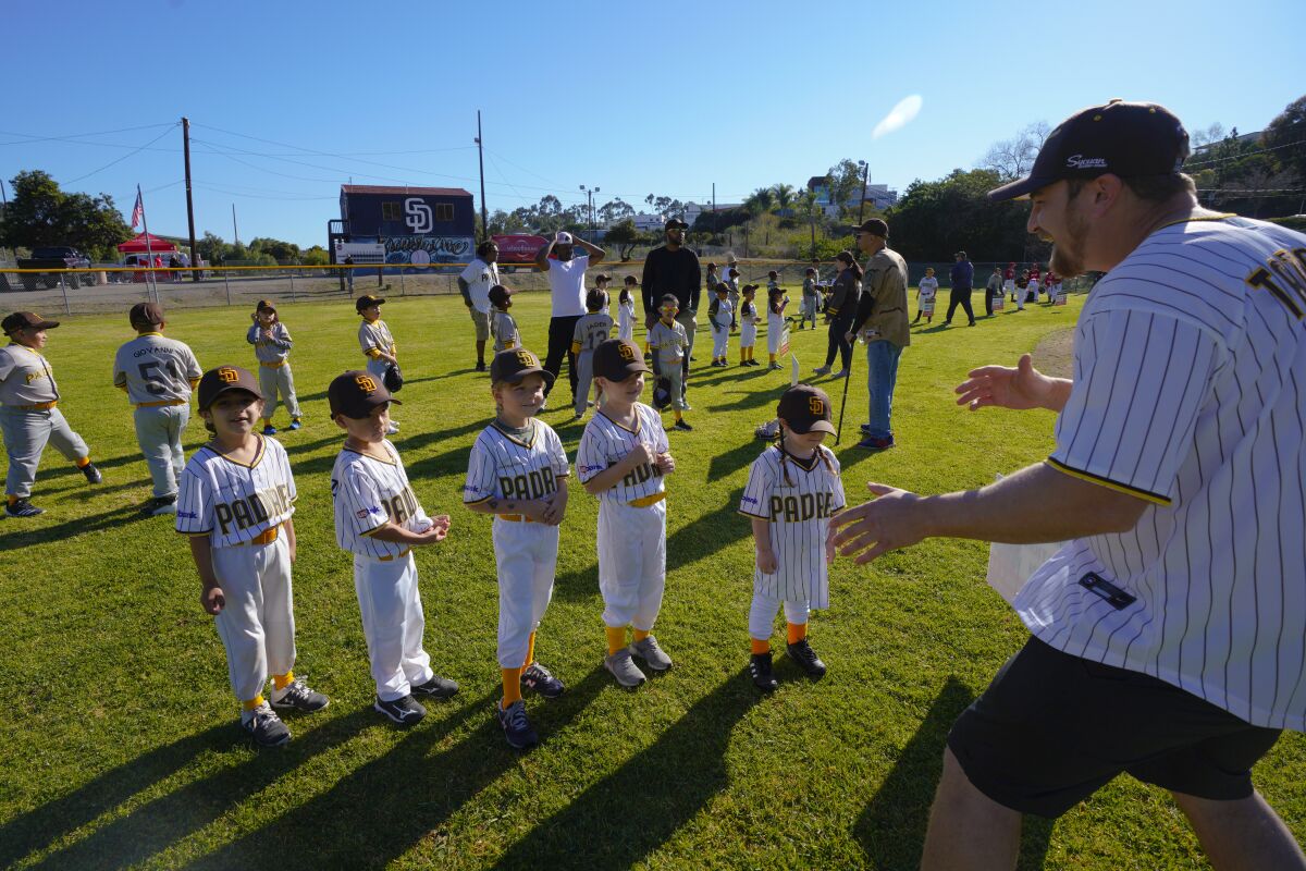 The Little Friars T-Ball team gets a pep talk from coach Kyle Rogers