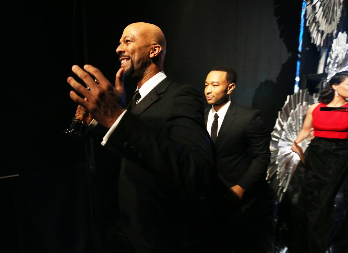 Common, left, and John Legend stand backstage at the Academy Awards. Oscar producers Craig Zadan and Neil Meron made it a priority to have the Oscars show look a little more like the people at home watching.