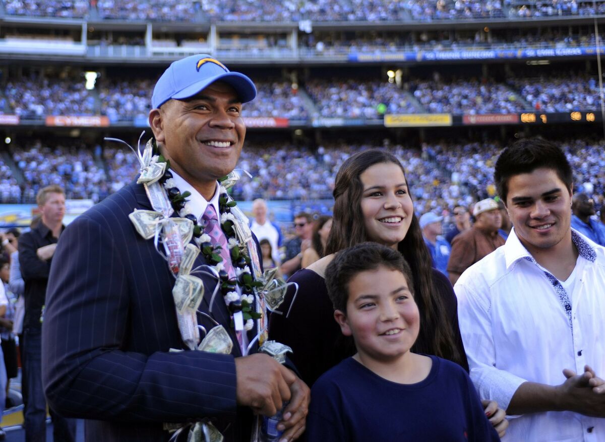 Junior Seau, along with his children, watch a video tribute as he was inducted into the Chargers Ring of Honor at halftime on Sunday, Nov. 27, 2011.