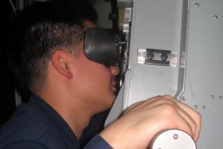Hany Hong operating the periscope on USS TOPEKA in 2014