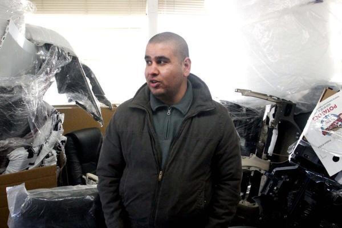 Iraqi immigrant Ubaida Mufrej stands in the office of his car parts export business in Seattle. Mufrej came to the United States under a special visa program for Iraqis who worked with U.S.-led forces during the Iraq War.