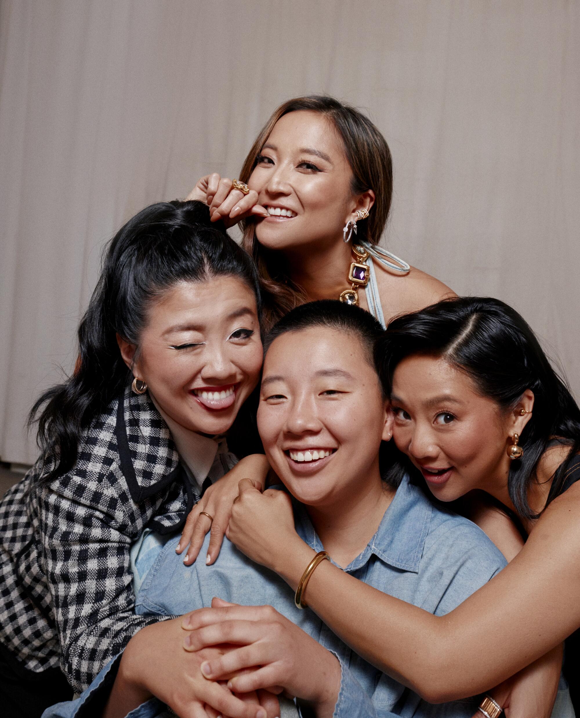 Four women hug and pose for the camera