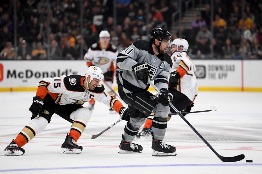 LOS ANGELES, CALIFORNIA - FEBRUARY 01: Anze Kopitar #11 of the Los Angeles Kings skates with the puck as he is chased by Ryan Getzlaf #15 of the Anaheim Ducks during the third period in a 3-1 Ducks win at Staples Center on February 01, 2020 in Los Angeles, California. (Photo by Harry How/Getty Images)