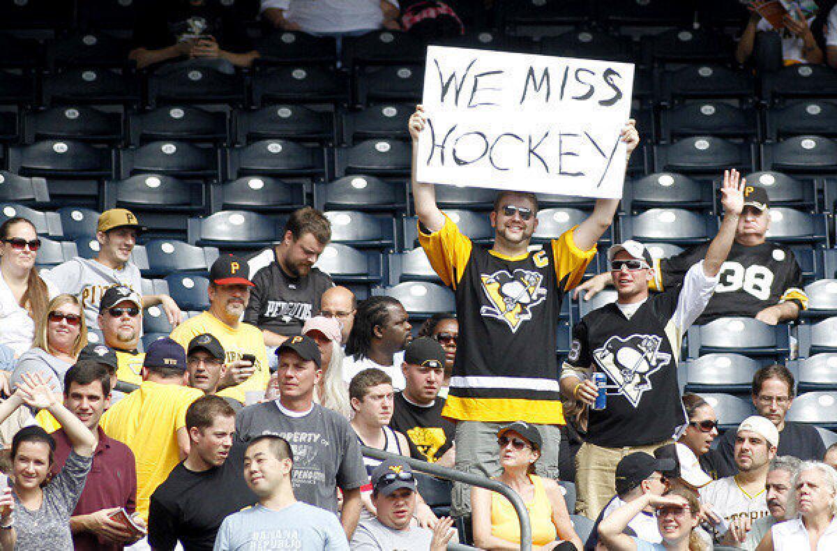 Fans at a Pirates-Braves game last month express their feelings about the NHL lockout.