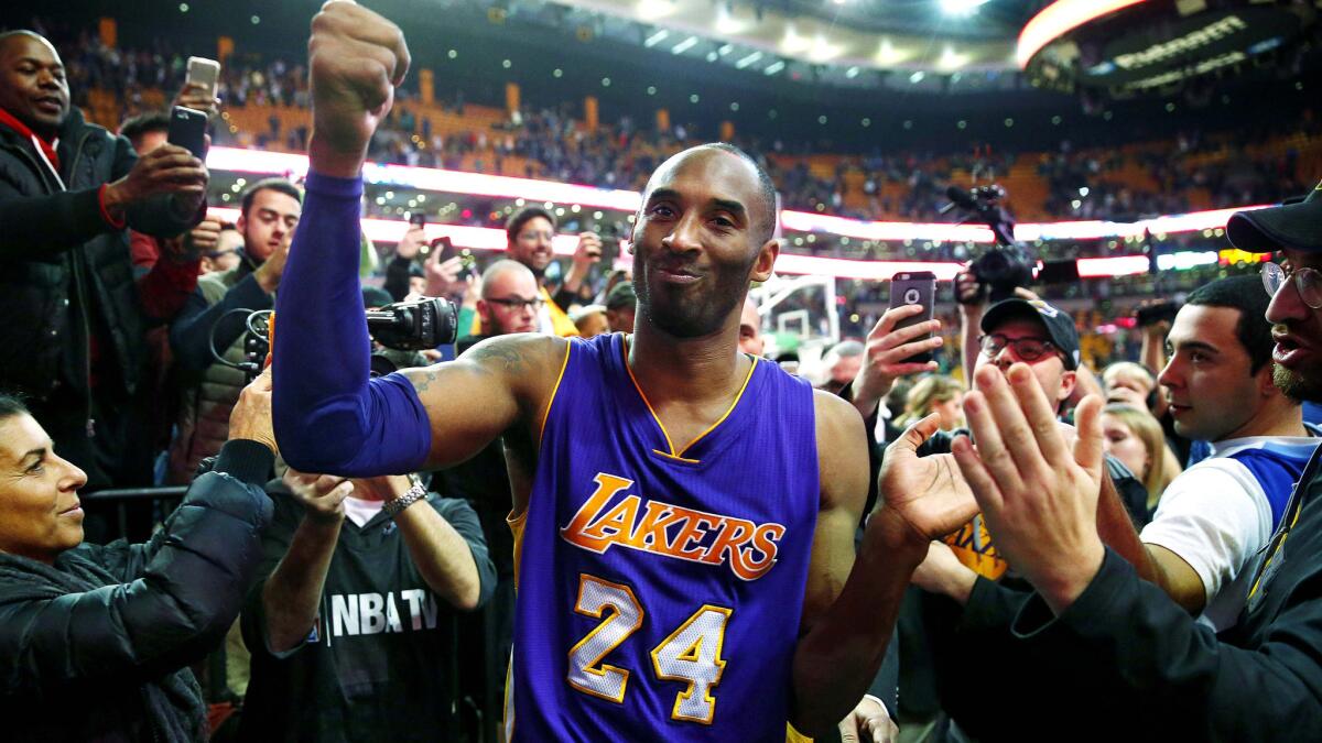 Kobe Bryant acknowledges the fans as he walks off the court in Boston following the Lakers' 112-104 victory over the Celtics on Thursday night.