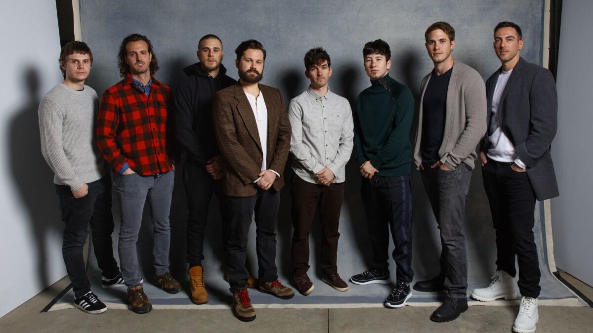From left, Evan Peters, Warren Lipka, Jared Abrahamson, Eric Borsuk, Spencer Reinhard, Barry Keoghan, Blake Jenner and Chas Allen, the actors and the real-life college students their characters were based on in "American Animals."