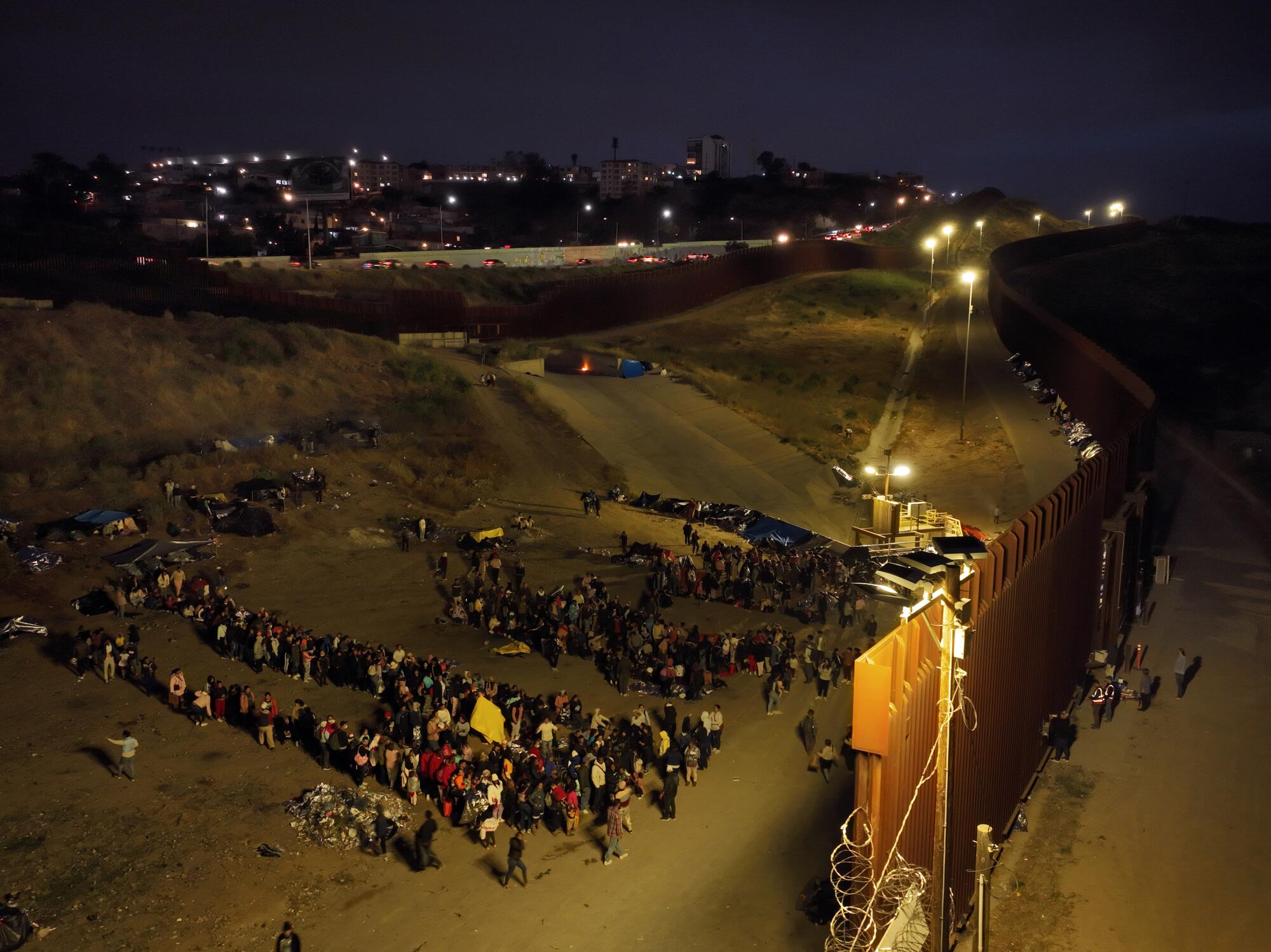 Migrants hoping to cross into the United States from Tijuana wait in an area north of the city.